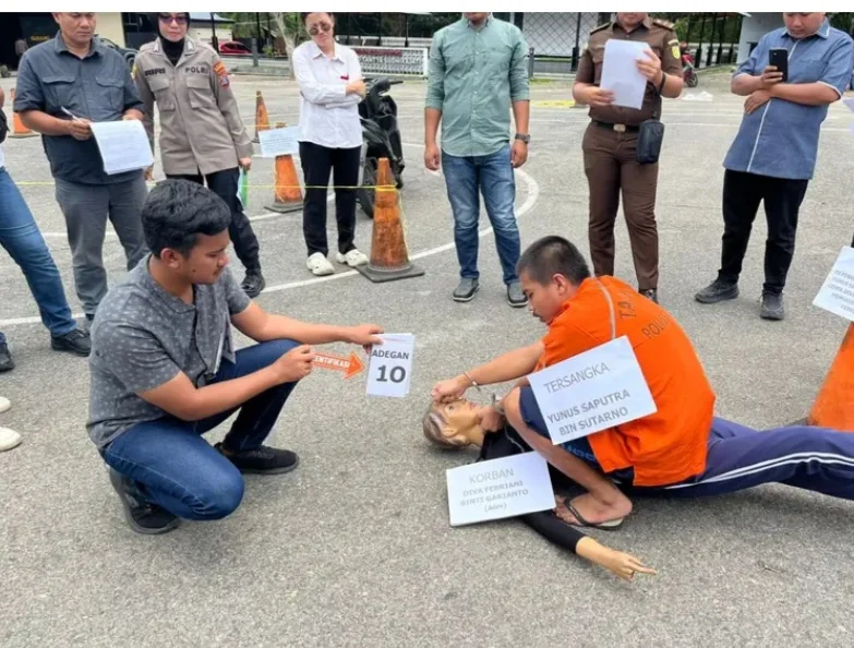 Tersangka Yunus Saputra memperagakan adegan dalam rekonstruksi kasus pembunuhan siswi DF di Mandailing Natal,Sumatera Utara.